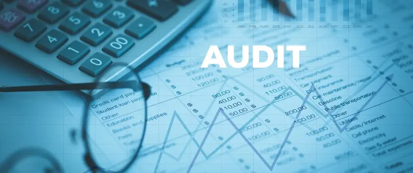 eBridgeRCM billing audit report with eye glasses and calculator